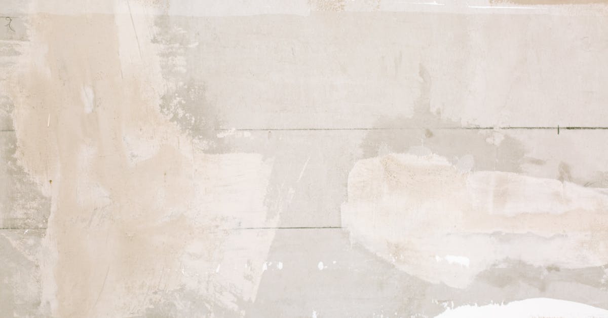 Close-up of an unfinished wall showing plaster and paint textures in a home renovation.
